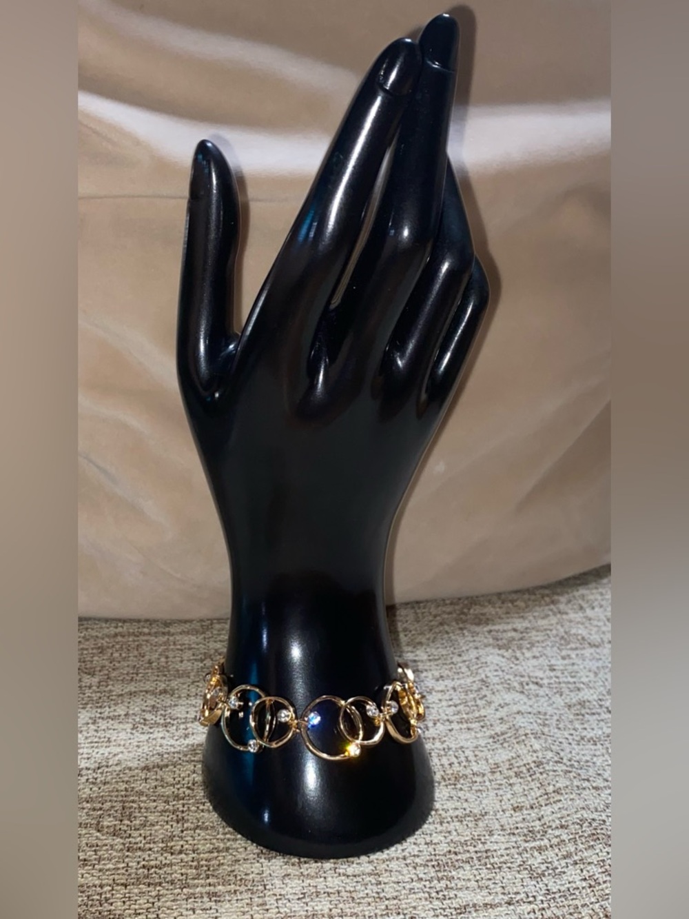 Interlocking loops and rhinestones gold tone bracelet